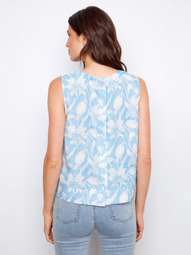 Delicate sleeveless blouse adorned with intricate floral design and back button accents for added charm by Charlie B.