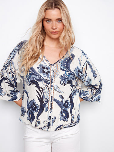 Women's blouse in an Ibiza-inspired print with V-neckline and ladder stitch accents for added flair by Charlie B.