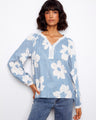 Blue floral blouse with a delicate crochet trim at the neckline, adding a touch of elegance to the overall design by Charlie B.