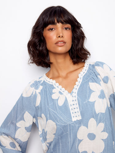Charming blue blouse featuring raglan sleeves, perfect for a relaxed and comfortable fit with floral patterns by Charlie B.