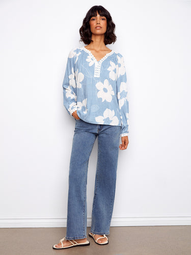 This stylish top showcases a notch neckline, beautifully complementing the large floral print for a chic look by Charlie B.