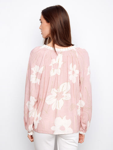Elegant pink top adorned with raglan sleeves and charming crochet detail on cuffs, offering comfort and style by Charlie B.