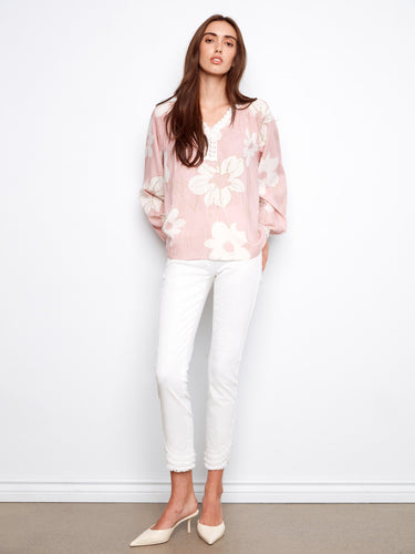 Stylish floral blouse showcasing a notch neckline with exquisite crochet accents for added sophistication by Charlie B.