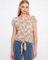 Beige printed blouse featuring a stylish boat neckline and cap sleeves, complete with a tie-front detail by Charlie B.