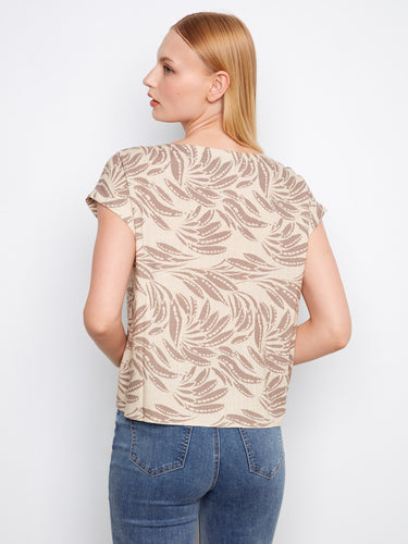 Stylish beige blouse adorned with an intricate print, featuring comfortable cap sleeves for ease of wear by Charlie B.