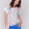 White floral top with crew neckline and side tie detail by Charlie B.