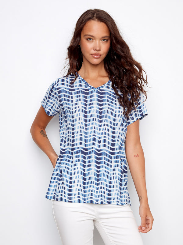 Blue and white patterned top with a stylish V-neck, offering a modern look. Perfect for casual outings by Charlie B.