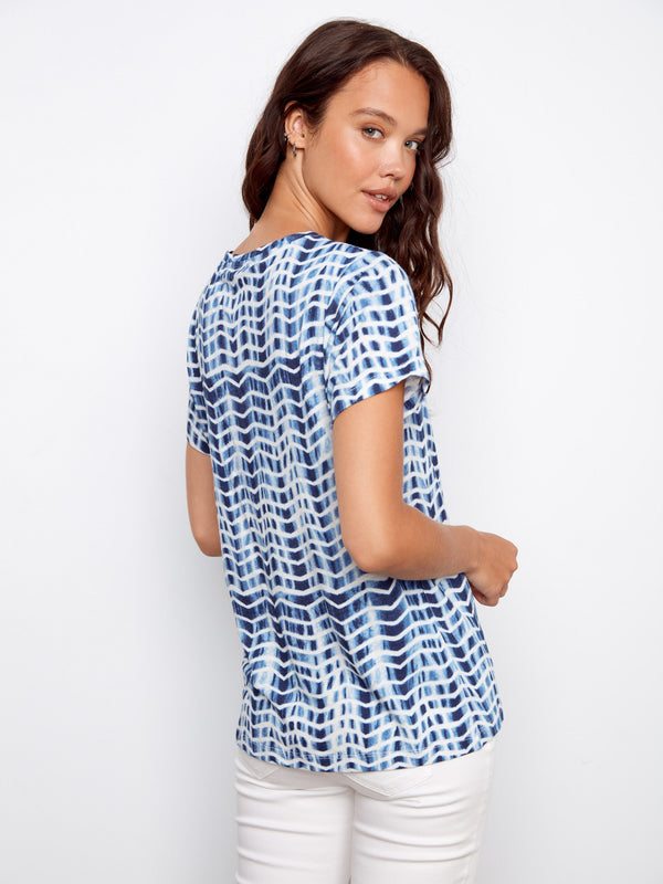 Short sleeves enhance the casual elegance of this blue and white top, making it versatile for any occasion by Charlie B.