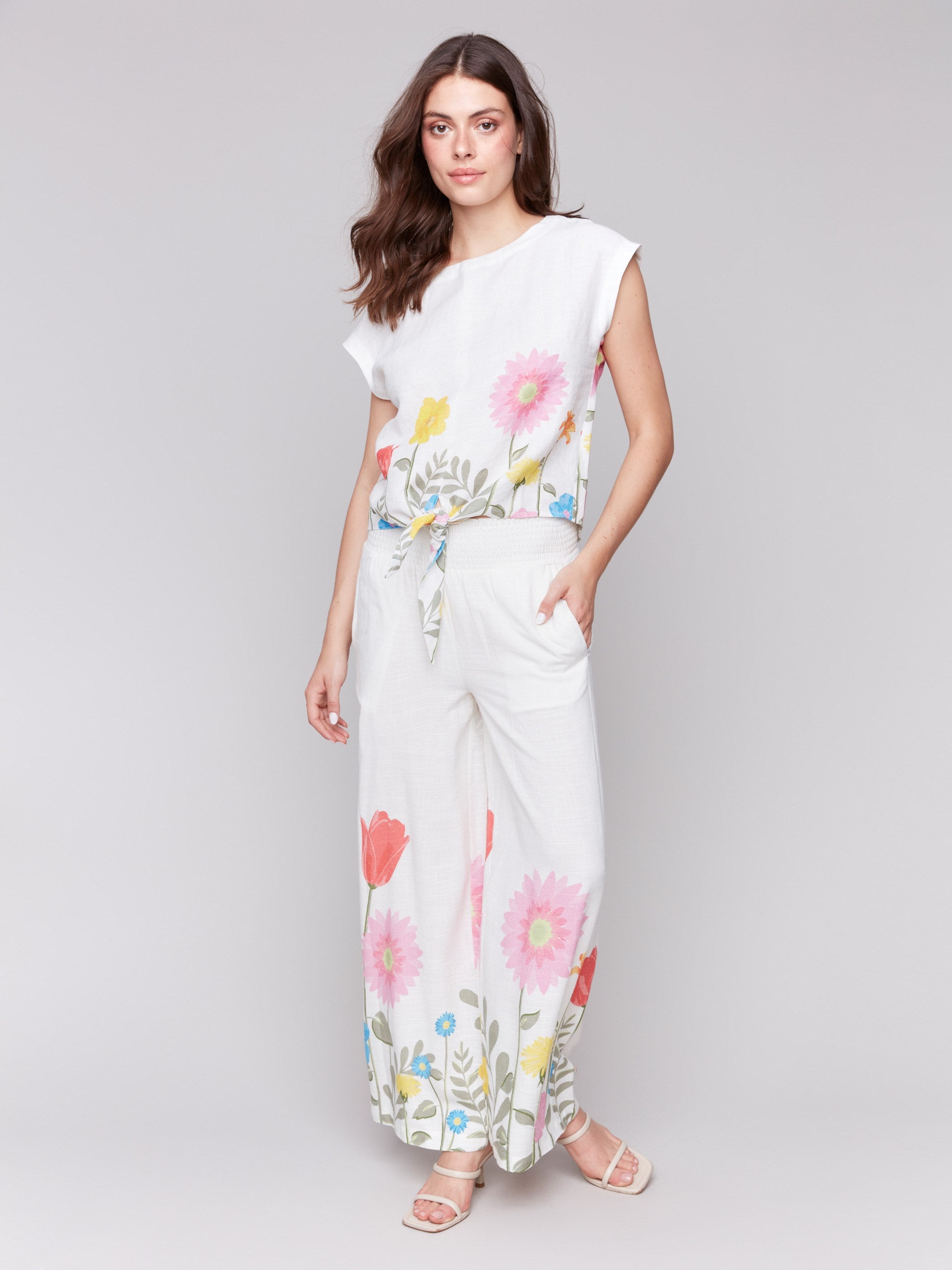 White pants with a wide leg design and smocked waistband, perfect for summer by Charlie B.