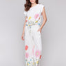 White pants with a wide leg design and smocked waistband, perfect for summer by Charlie B.