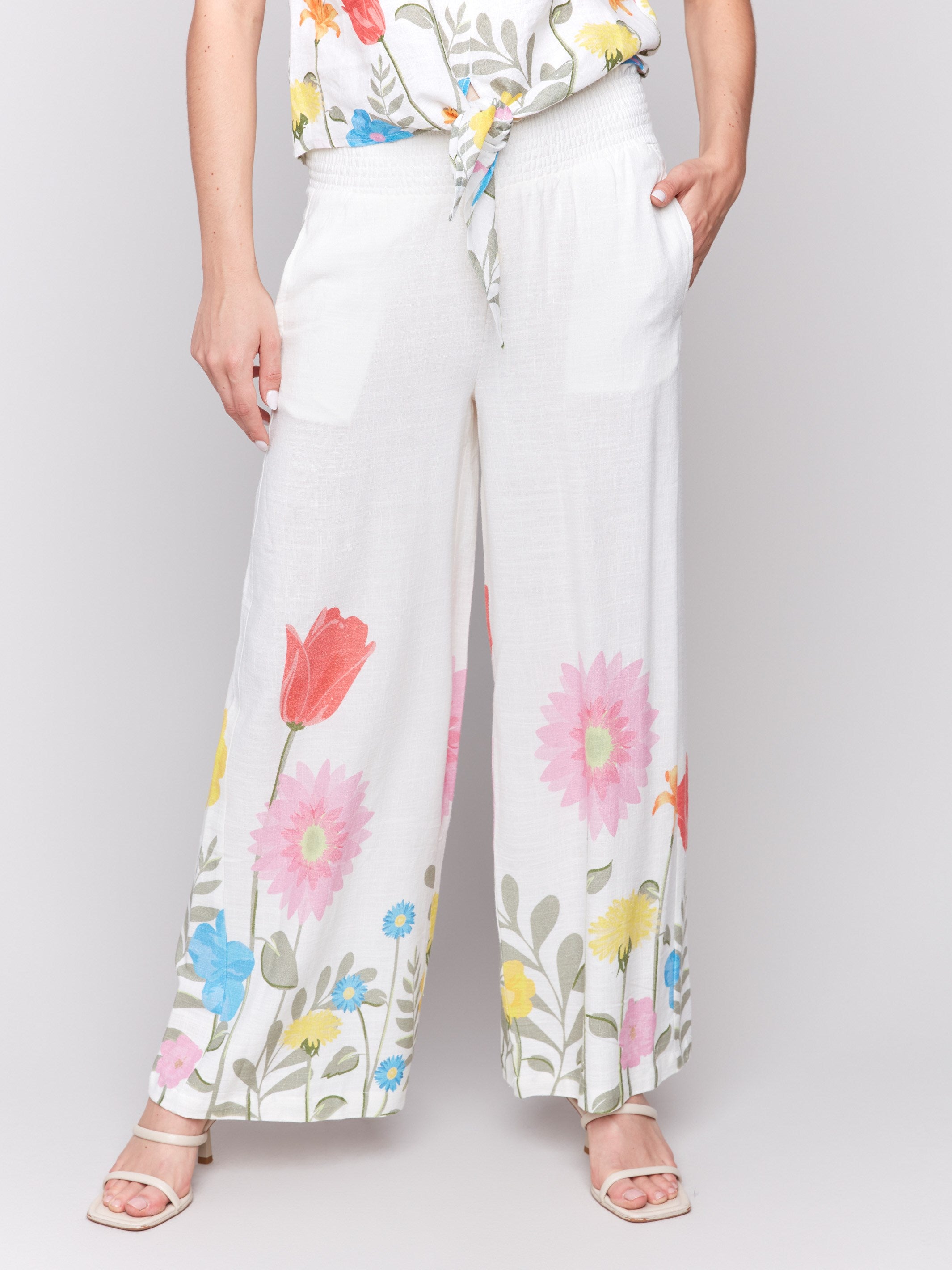Elegant pull-on style white pants with a colorful floral border by Charlie B.