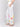 Chic white pants featuring convenient side pockets and vibrant floral accents by Charlie B.