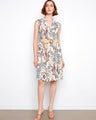 Floral dress with a tailored neckline and cap sleeves, featuring a stylish straw belt for added flair. By Charlie B.