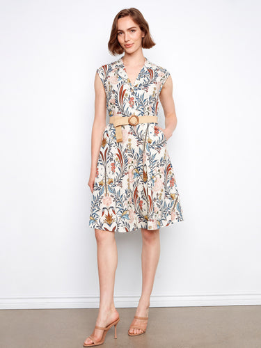 Half-button design enhances the floral pattern of this knee-length dress with cap sleeves. By Charlie B.