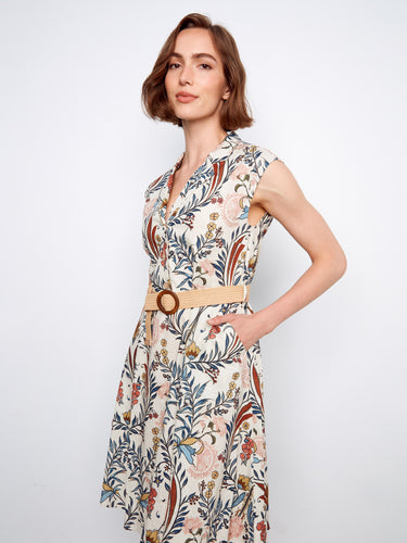Cap sleeves highlight the half-button design of this beautifully patterned floral dress. By Charlie B.