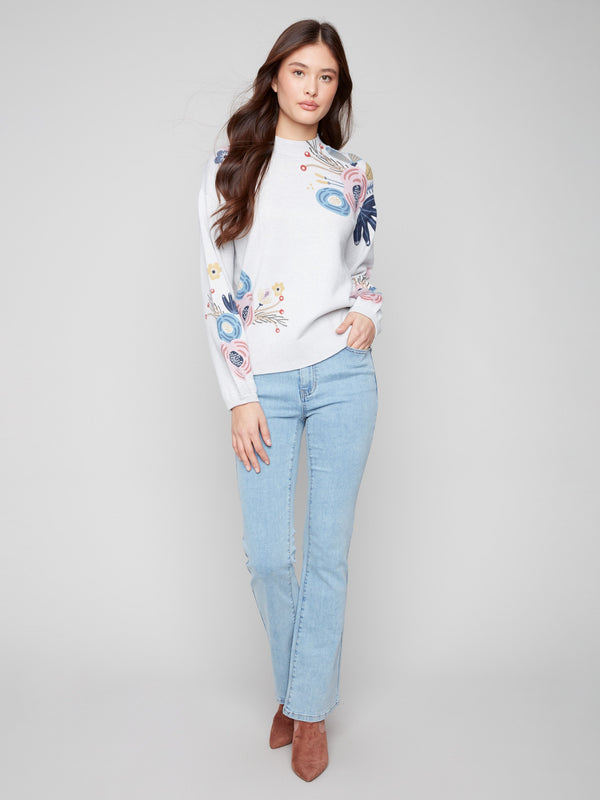 Elegant long balloon sleeves add flair to this light grey sweater with floral accents by Charlie B.