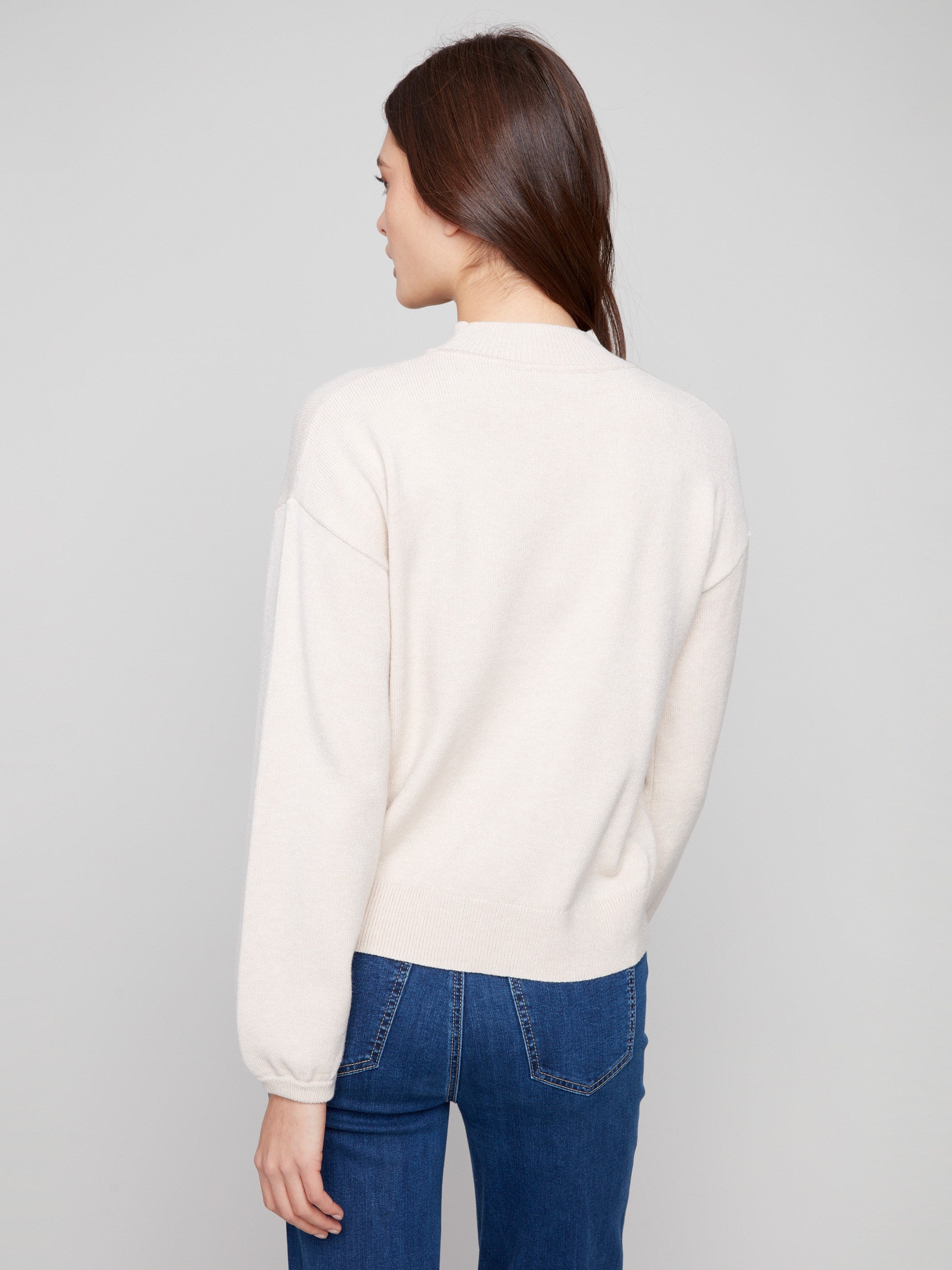 Soft heather oat sweater showcasing elegant balloon sleeves and elastic cuffs by Charlie B.