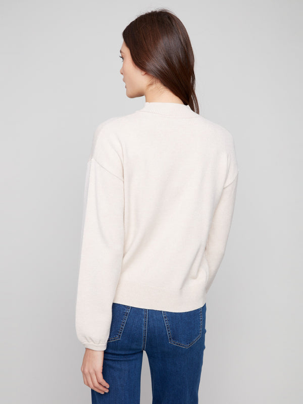 Soft heather oat sweater showcasing elegant balloon sleeves and elastic cuffs by Charlie B.
