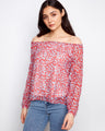 Red blouse with off-the-shoulder neckline and charming floral design, paired with jeans for a casual look by Charlie B.