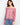 Red blouse with off-the-shoulder neckline and charming floral design, paired with jeans for a casual look by Charlie B.