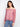 Red blouse with off-the-shoulder neckline and charming floral design, paired with jeans for a casual look by Charlie B.