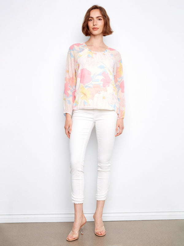 Floral top showcasing an intricate pattern that brings vibrant colors to your wardrobe by Charlie B.