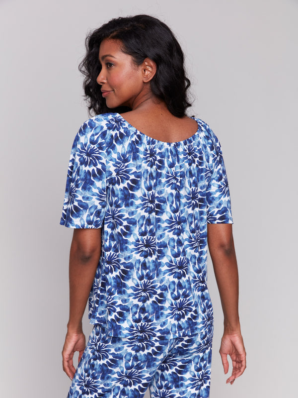 Trendy off-the-shoulder style in blue print by Charlie B.