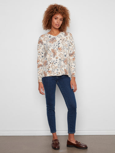 This plush knit sweater features long sleeves and a charming floral pattern for added elegance by Charlie B.