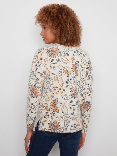 Stylish side slits complement the floral print on this cozy V-neck sweater by Charlie B.