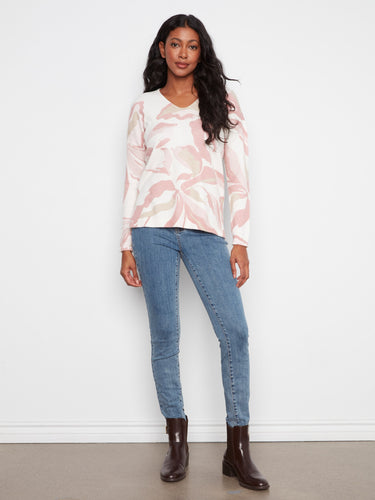 This sweater features long sleeves, offering warmth and style for cooler days. A versatile piece by Charlie B.