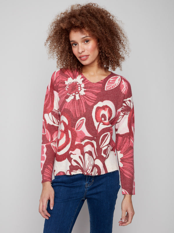 Floral print sweater with plush texture, showcasing vibrant red and pink hues in a cozy design by Charlie B.