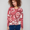 Floral print sweater with plush texture, showcasing vibrant red and pink hues in a cozy design by Charlie B.