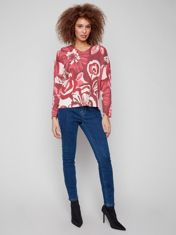 V-neck floral sweater in rich reds and pinks, featuring long sleeves for added warmth by Charlie B.