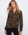 This top features a stylish notch neckline, adding a touch of elegance to any outfit. Made from soft viscose fabric by Charlie B.
