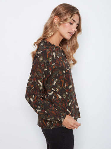 The unique pattern on this top highlights its fashionable design, making it versatile for various looks. Created by Charlie B.