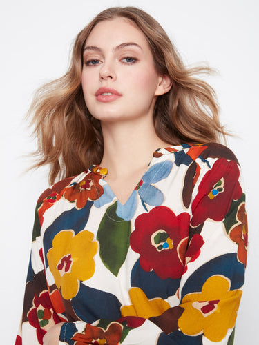Chic blouse adorned with a lively floral design, offering raglan sleeves and a comfortable feel by Charlie B.