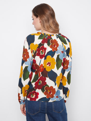 Colorful flower-patterned blouse crafted in soft viscose, featuring raglan sleeves for added flair by Charlie B.
