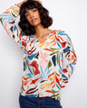 A chic top adorned with a notched neckline and eye-catching colors, perfect for any occasion. By Charlie B.