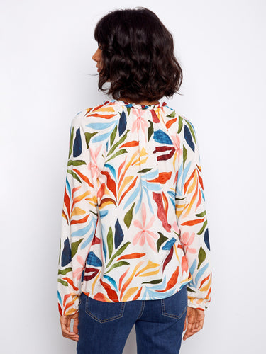 Stylish top with intricate braided collar detail and colorful design, offering both comfort and style. By Charlie B.