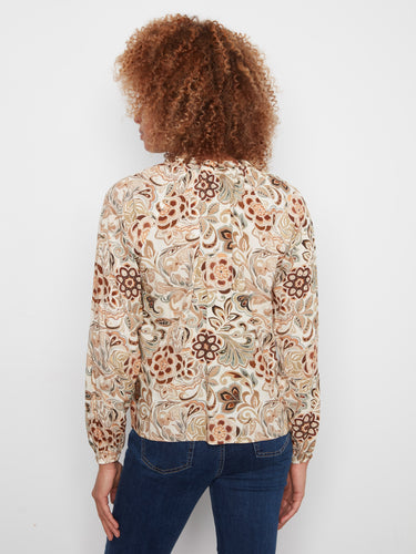 This floral patterned blouse is made from soft viscose fabric, ensuring breathability and style. By Charlie B.