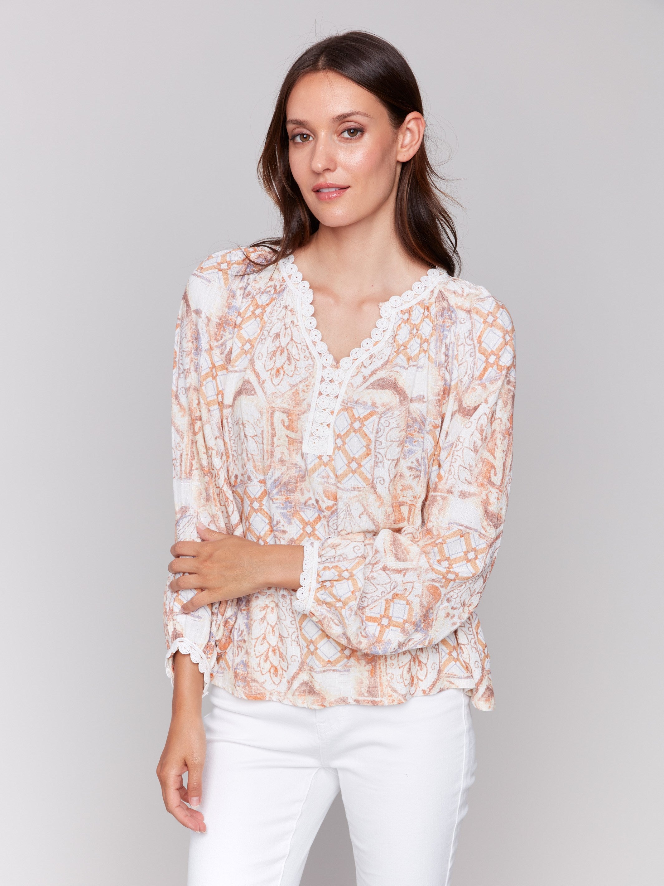 Papaya colored blouse with lace trim at neckline and cuffs by Charlie B.
