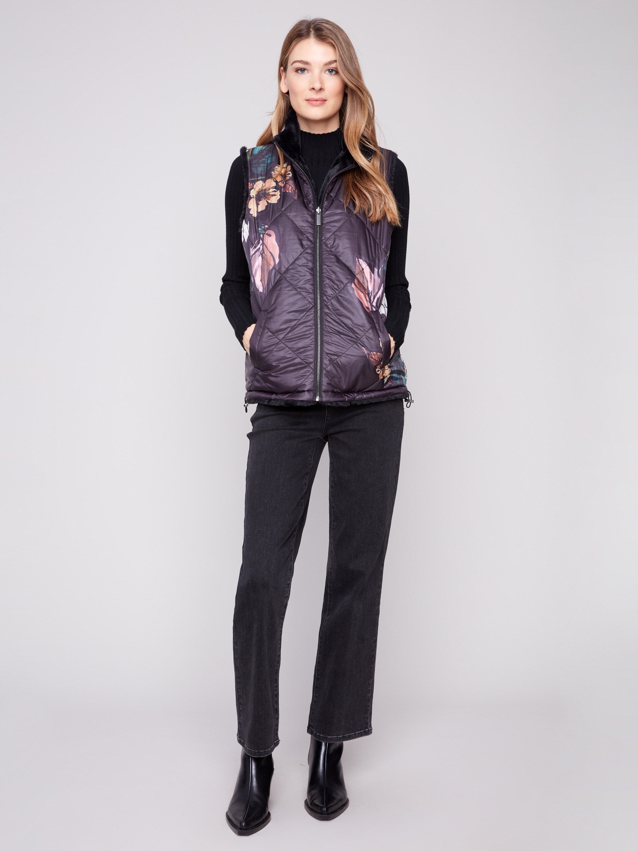 Quilted vest featuring a vibrant floral pattern with a convenient zipper front closure by Charlie B.