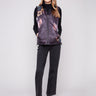Quilted vest featuring a vibrant floral pattern with a convenient zipper front closure by Charlie B.