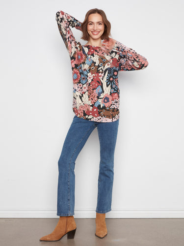 This vibrant floral top includes stylish drop shoulders for a relaxed and chic look by Charlie B.