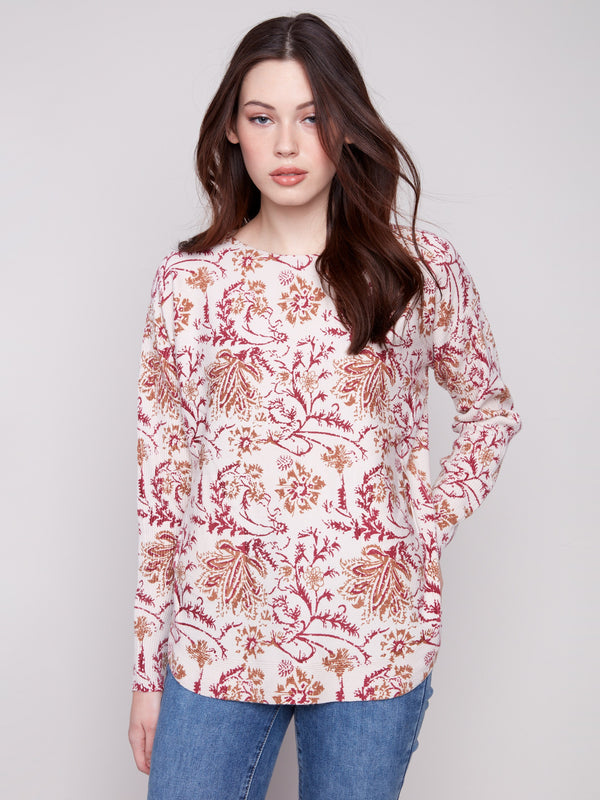 Calico sweater with a boat neck and abstract floral print, featuring ribbed sleeves for added texture by Charlie B.