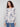 Blush sweater featuring a boat neck and abstract floral print, perfect for a chic look by Charlie B.