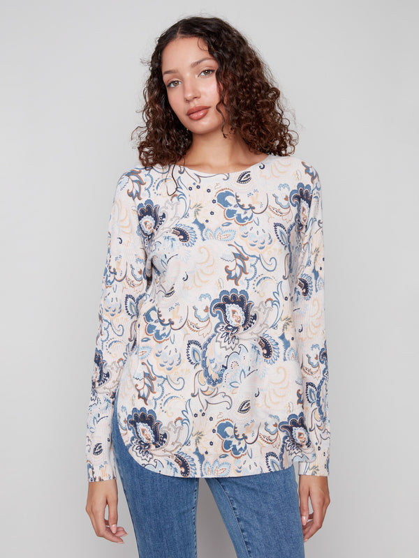 Blush sweater featuring a boat neck and abstract floral print, perfect for a chic look by Charlie B.