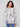 Elegant blush sweater with side slits and floral design for added flair by Charlie B.