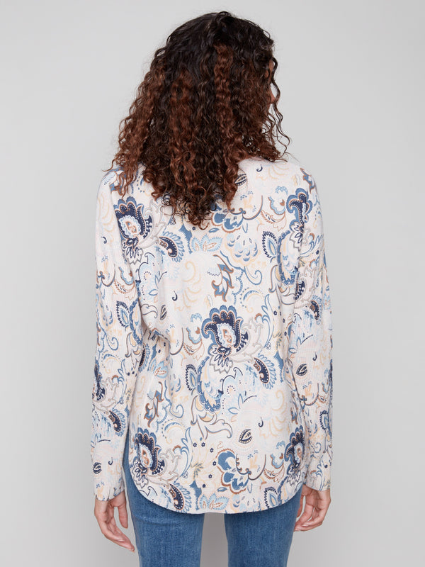 Charming blush sweater showcasing a rounded hem and floral pattern by Charlie B.