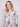 Stylish blush sweater with side pockets, adorned in an abstract floral print by Charlie B.
